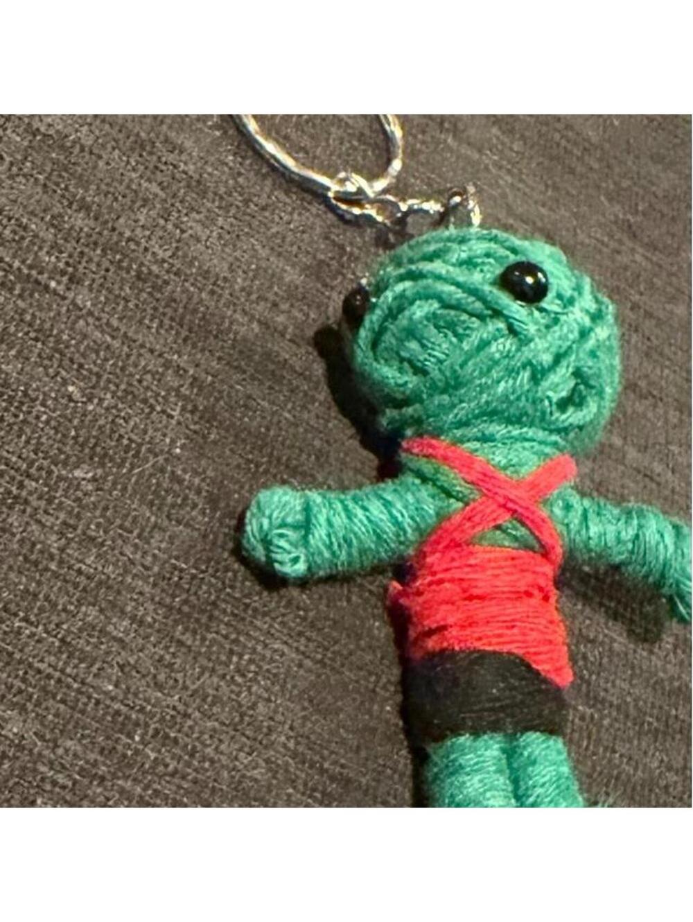 Cute little yarn voodoo keychain. Green, red & black yarn doll keychain.